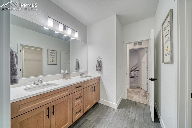9473 Bugaboo Dr, Colorado Springs, CO 80924 - bathroom featuring double vanity, ensuite bathroom, and baseboards