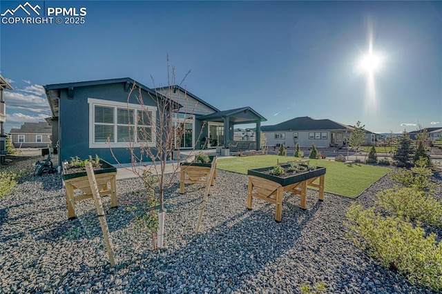 9473 Bugaboo Dr, Colorado Springs, CO 80924 - rear view of house featuring a patio, a garden, and stucco siding