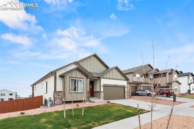 12879 Morning Creek Ln, Peyton, CO 80831 - craftsman house featuring board and batten siding, driveway, stone siding, a garage, and a residential view