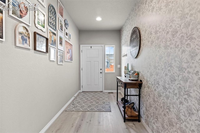 12879 Morning Creek Ln, Peyton, CO 80831 - entryway featuring wood finished floors, baseboards, and recessed lighting