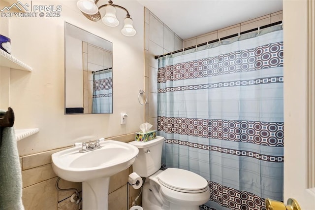 1409 Evergreen Dr, Colorado Springs, CO 80911 - full bathroom with toilet, a shower with shower curtain, and tile walls