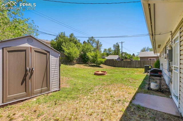 1409 Evergreen Dr, Colorado Springs, CO 80911 - view of yard featuring an outdoor fire pit and central air condition unit