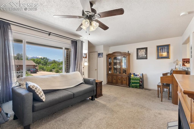 1409 Evergreen Dr, Colorado Springs, CO 80911 - living area with a ceiling fan, a textured ceiling, and light colored carpet