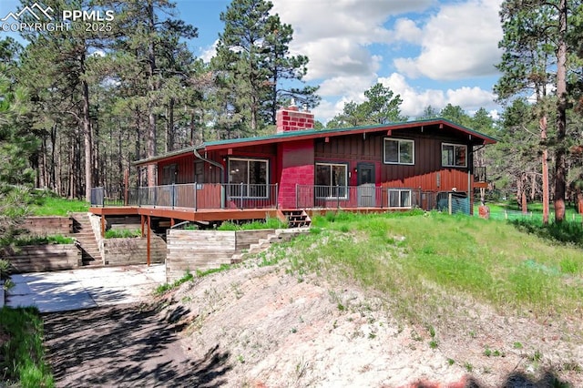 17990 Canterbury Dr, Monument, CO 80132 - view of front of property with a chimney, stairway, and a deck