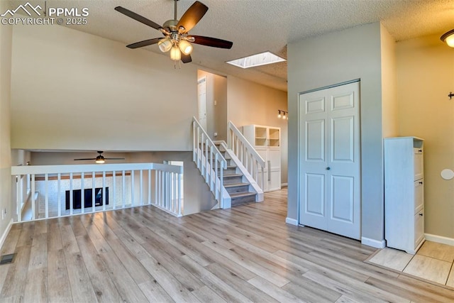 4472 Eastcrest Cir, Colorado Springs, CO 80916 - unfurnished room with a ceiling fan, wood finished floors, a skylight, a textured ceiling, and baseboards