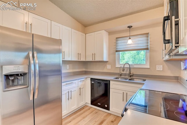 4472 Eastcrest Cir, Colorado Springs, CO 80916 - kitchen with black appliances, a sink, white cabinets, a textured ceiling, and light wood finished floors