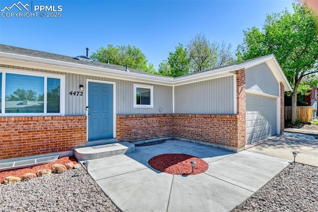 4472 Eastcrest Cir, Colorado Springs, CO 80916 - view of front of home featuring brick siding, a garage, and concrete driveway