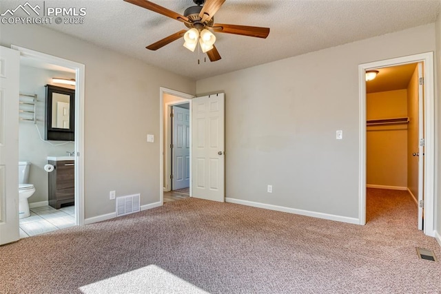 4472 Eastcrest Cir, Colorado Springs, CO 80916 - unfurnished bedroom featuring a spacious closet, carpet flooring, baseboards, and a textured ceiling