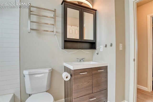 4472 Eastcrest Cir, Colorado Springs, CO 80916 - full bathroom with toilet, vanity, and wood finished floors