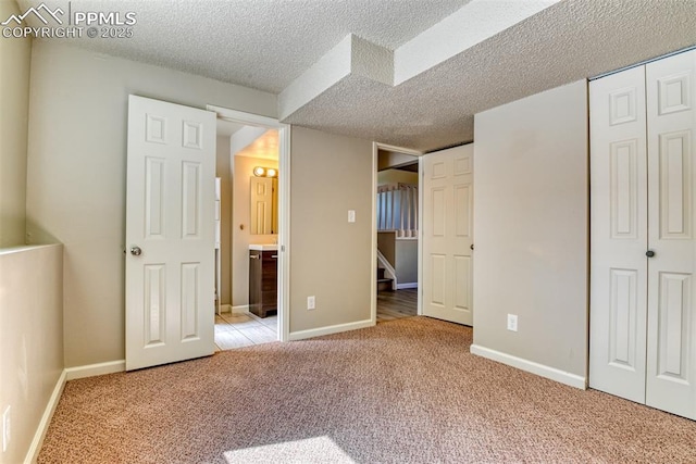 4472 Eastcrest Cir, Colorado Springs, CO 80916 - unfurnished bedroom with carpet, a closet, a textured ceiling, and baseboards