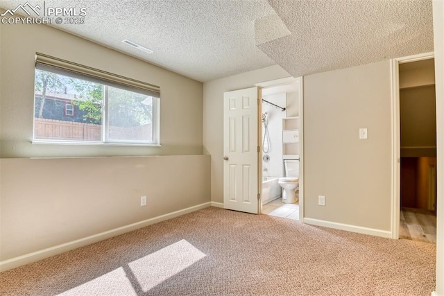 4472 Eastcrest Cir, Colorado Springs, CO 80916 - unfurnished bedroom with carpet floors, a textured ceiling, baseboards, and ensuite bathroom