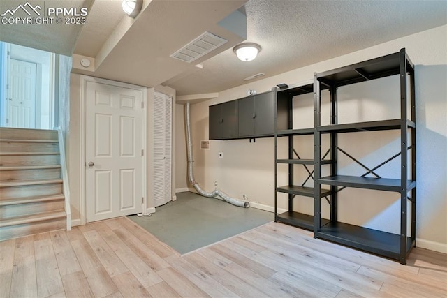 4472 Eastcrest Cir, Colorado Springs, CO 80916 - finished below grade area featuring baseboards, wood finished floors, stairway, and a textured ceiling