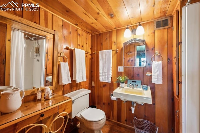 3875 Overlook Rd, Colorado Springs, CO 80906 - bathroom with wooden ceiling, wood walls, curtained shower, and wood finished floors