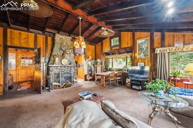 3875 Overlook Rd, Colorado Springs, CO 80906 - living room featuring plenty of natural light, carpet flooring, wooden walls, wooden ceiling, and a stone fireplace