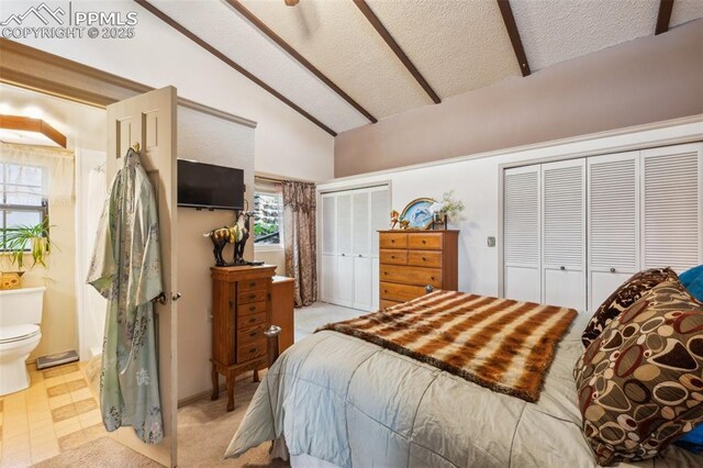 3875 Overlook Rd, Colorado Springs, CO 80906 - bedroom with lofted ceiling, multiple closets, connected bathroom, and a textured ceiling