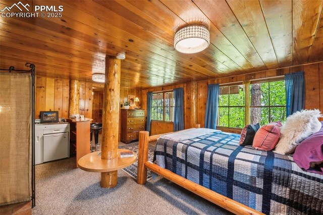 3875 Overlook Rd, Colorado Springs, CO 80906 - bedroom with wooden ceiling, wood walls, and carpet floors