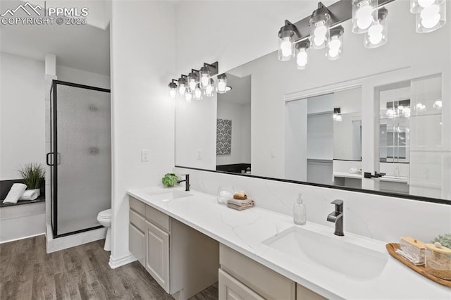 4430 Songglen Cir, Colorado Springs, CO 80906 - full bath with double vanity, a stall shower, toilet, wood finished floors, and a chandelier