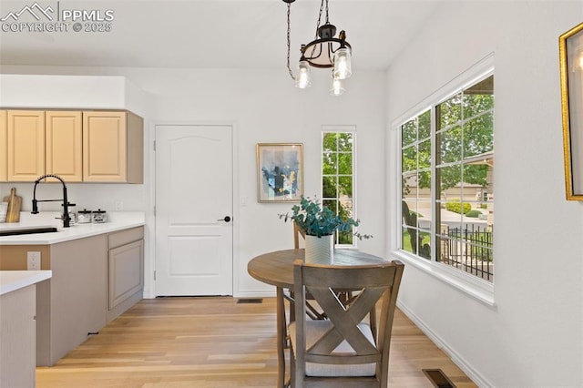 4430 Songglen Cir, Colorado Springs, CO 80906 - dining area featuring light wood-style flooring, a chandelier, and baseboards