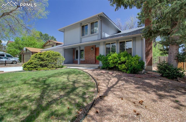 3177 Blue Mountain Way, Colorado Springs, CO 80906 - traditional home featuring a porch, brick siding, and a chimney