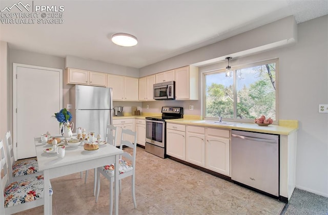 3177 Blue Mountain Way, Colorado Springs, CO 80906 - kitchen featuring stainless steel appliances, a sink, light countertops, and baseboards