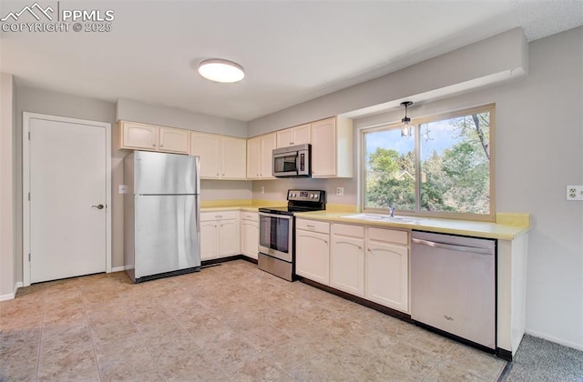 3177 Blue Mountain Way, Colorado Springs, CO 80906 - kitchen with appliances with stainless steel finishes, a sink, light countertops, and baseboards