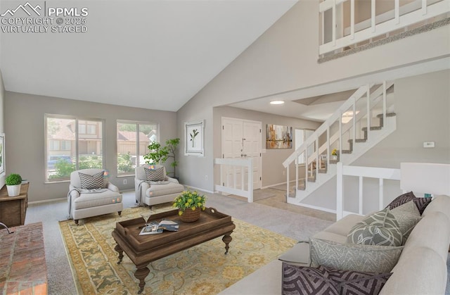 3177 Blue Mountain Way, Colorado Springs, CO 80906 - carpeted living area featuring high vaulted ceiling, baseboards, and stairway
