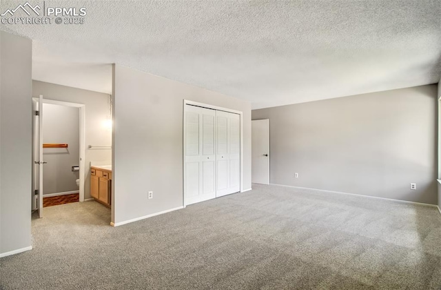 3177 Blue Mountain Way, Colorado Springs, CO 80906 - unfurnished bedroom with carpet floors, baseboards, a closet, and a textured ceiling