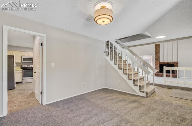 3177 Blue Mountain Way, Colorado Springs, CO 80906 - basement featuring freestanding refrigerator, light colored carpet, a brick fireplace, and stairs