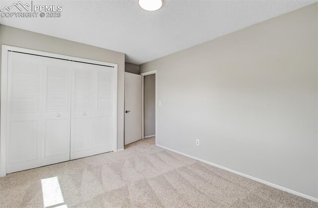 3177 Blue Mountain Way, Colorado Springs, CO 80906 - unfurnished bedroom featuring carpet flooring, baseboards, and a closet