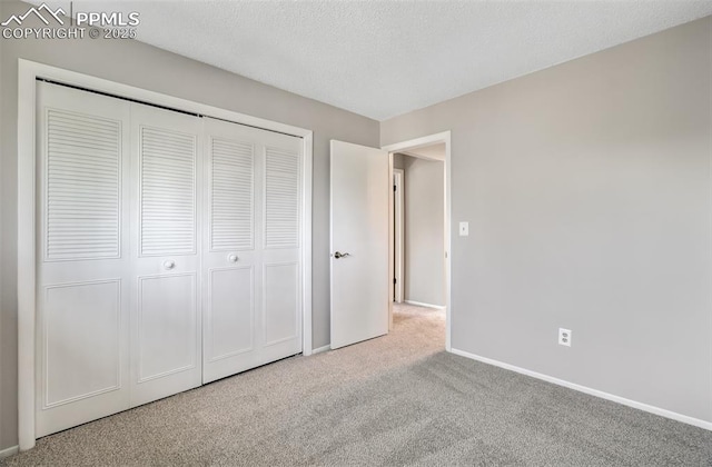3177 Blue Mountain Way, Colorado Springs, CO 80906 - unfurnished bedroom featuring carpet flooring, baseboards, a closet, and a textured ceiling