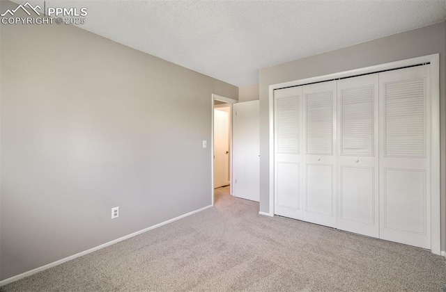 3177 Blue Mountain Way, Colorado Springs, CO 80906 - unfurnished bedroom featuring carpet flooring, baseboards, a closet, and a textured ceiling