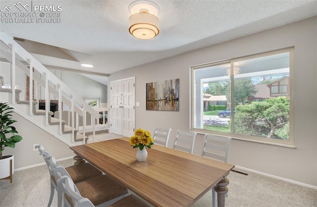 3177 Blue Mountain Way, Colorado Springs, CO 80906 - carpeted dining space featuring stairs, baseboards, and a textured ceiling