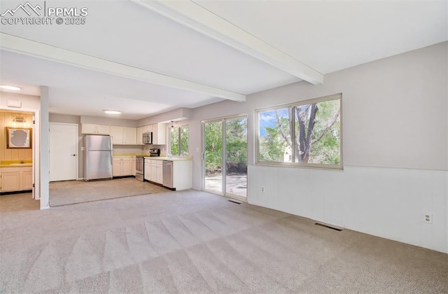 3177 Blue Mountain Way, Colorado Springs, CO 80906 - unfurnished living room with light carpet, beamed ceiling, and a sink