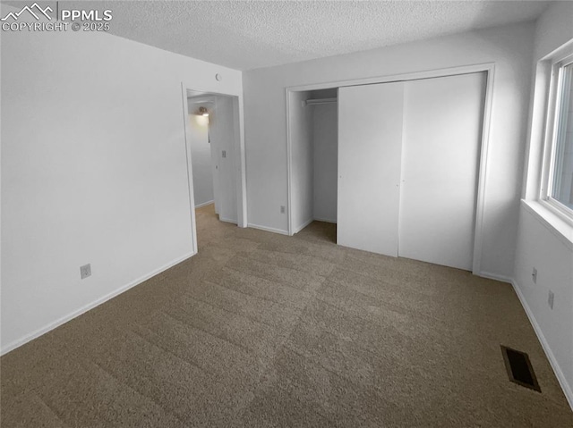 937 Moorings Dr, Colorado Springs, CO 80906 - unfurnished bedroom with carpet flooring, a textured ceiling, a closet, and baseboards