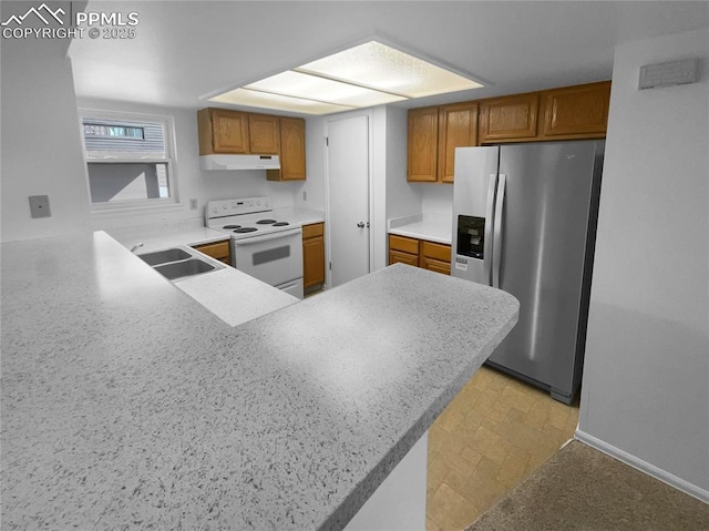 937 Moorings Dr, Colorado Springs, CO 80906 - kitchen featuring stainless steel fridge, electric stove, under cabinet range hood, a sink, and brown cabinets