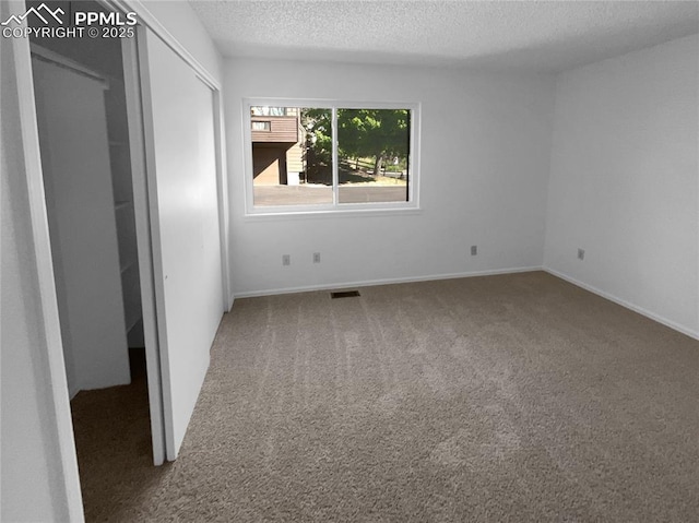937 Moorings Dr, Colorado Springs, CO 80906 - unfurnished bedroom with carpet floors, a textured ceiling, and baseboards