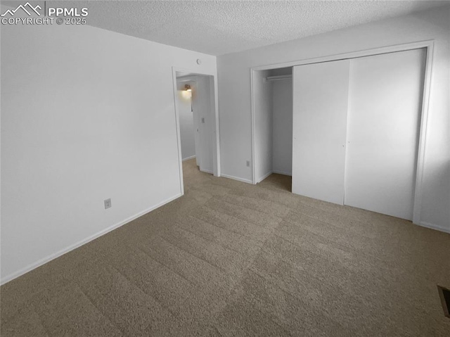 937 Moorings Dr, Colorado Springs, CO 80906 - unfurnished bedroom featuring carpet flooring, a textured ceiling, a closet, and baseboards
