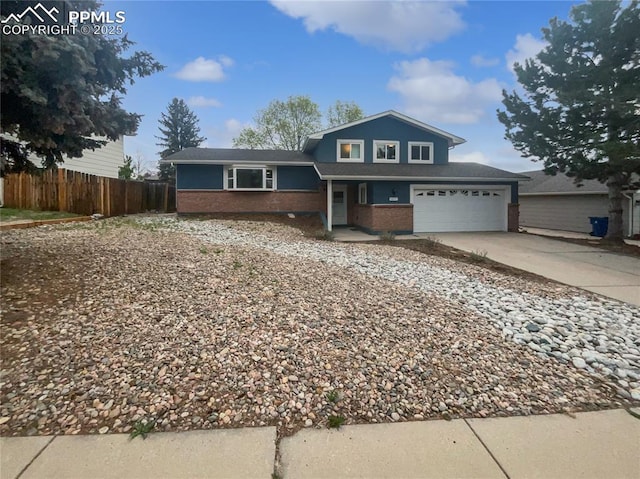 5570 Whimsical Dr, Colorado Springs, CO 80917 - tri-level home with concrete driveway, brick siding, and an attached garage