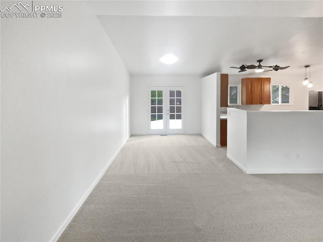 5570 Whimsical Dr, Colorado Springs, CO 80917 - unfurnished living room with light colored carpet, baseboards, a ceiling fan, and french doors
