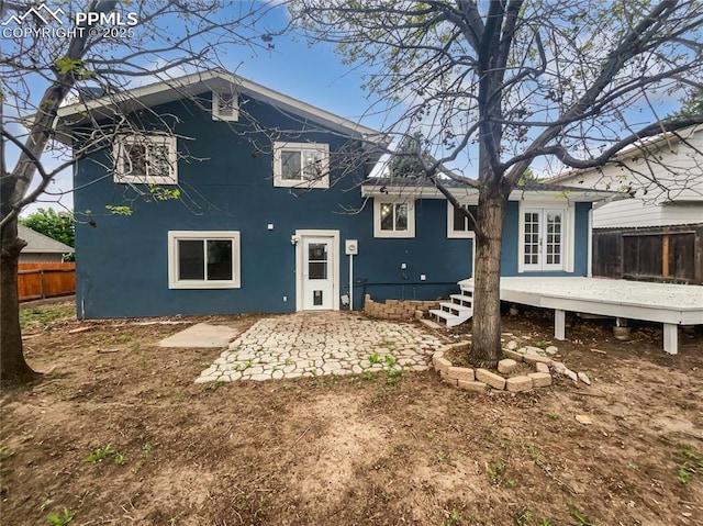 5570 Whimsical Dr, Colorado Springs, CO 80917 - back of house with french doors, a wooden deck, stucco siding, and a patio