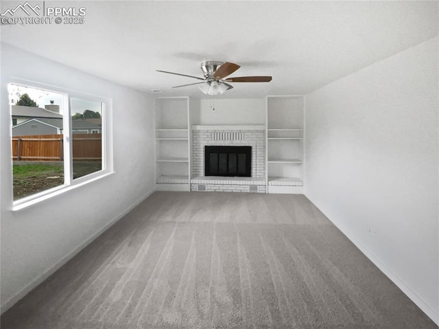 5570 Whimsical Dr, Colorado Springs, CO 80917 - unfurnished living room featuring carpet floors, ceiling fan, baseboards, a fireplace, and built in shelves