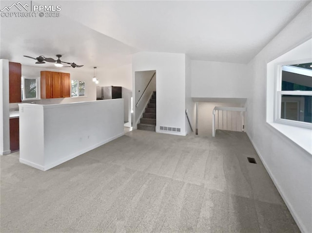 5570 Whimsical Dr, Colorado Springs, CO 80917 - unfurnished living room with light carpet, ceiling fan, and baseboards