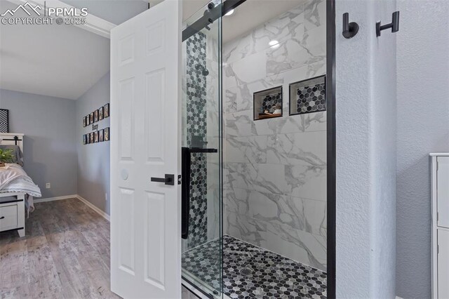 14213 Woodrock Path, Colorado Springs, CO 80921 - full bath with a shower stall, wood finished floors, and baseboards