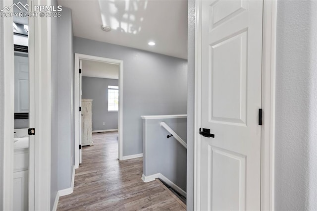 14213 Woodrock Path, Colorado Springs, CO 80921 - hallway featuring baseboards, wood finished floors, recessed lighting, and an upstairs landing