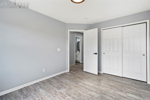 14213 Woodrock Path, Colorado Springs, CO 80921 - unfurnished bedroom with wood finished floors, baseboards, and a closet