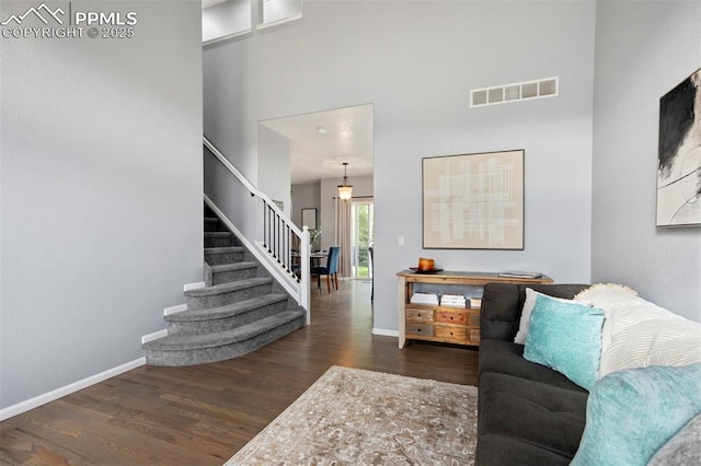 14213 Woodrock Path, Colorado Springs, CO 80921 - living room with stairway, wood finished floors, a high ceiling, and baseboards