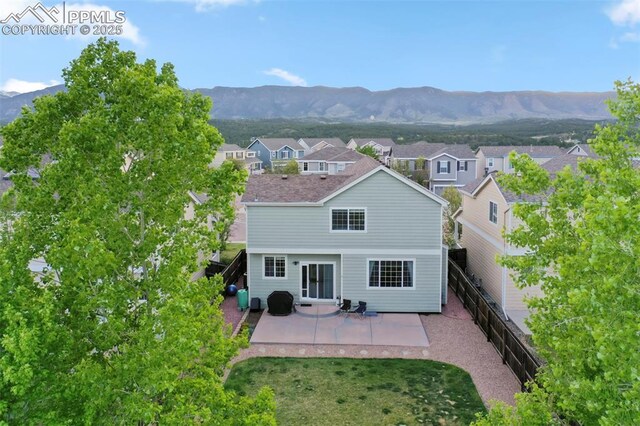 14213 Woodrock Path, Colorado Springs, CO 80921 - back of property featuring a patio, a mountain view, and a residential view