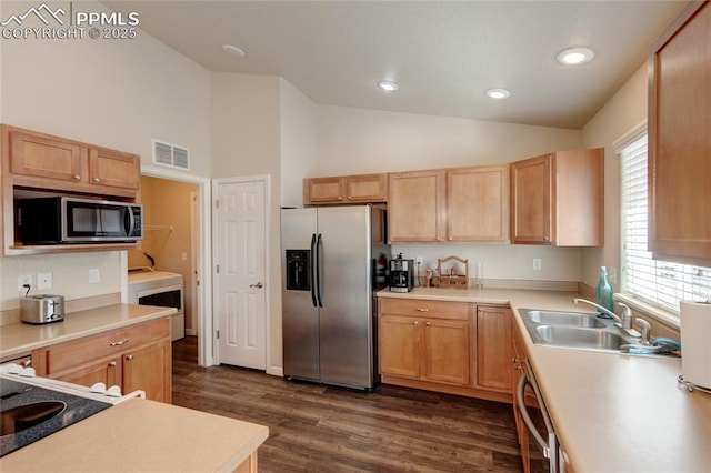 11933 Corbu Hts, Peyton, CO 80831 - kitchen with stainless steel appliances, high vaulted ceiling, washer / dryer, dark wood-type flooring, and healthy amount of natural light
