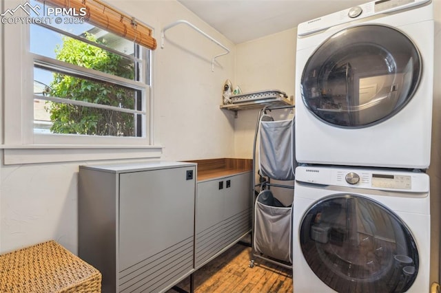 2430 N Tejon St, Colorado Springs, CO 80907 - laundry area featuring stacked washer and clothes dryer, healthy amount of natural light, and wood finished floors
