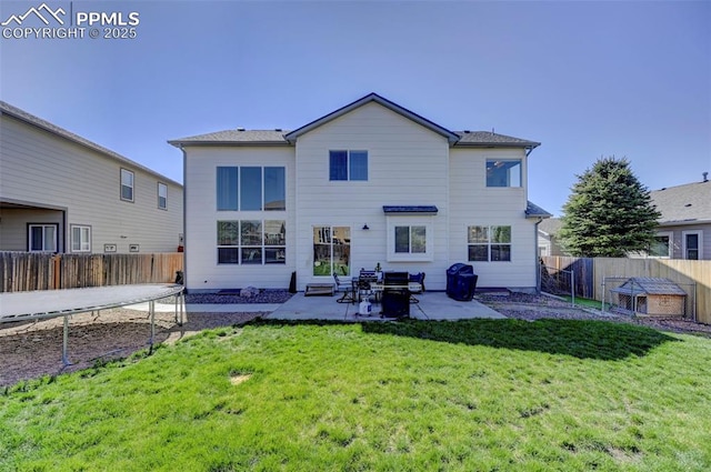 10368 Mount Evans Dr, Peyton, CO 80831 - back of property featuring a trampoline and a patio area